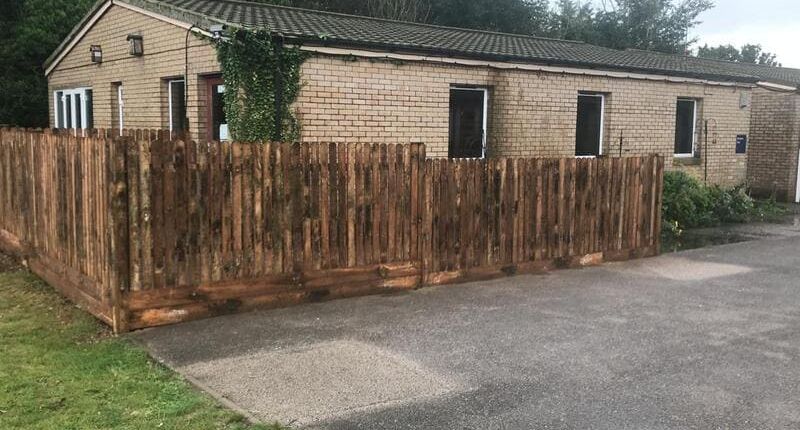 Dark stained picket fence Dark stained picket fence